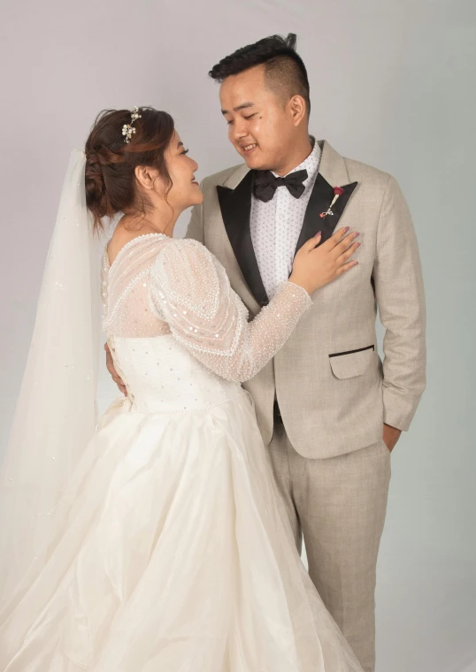 a young bride and groom pose for the camera