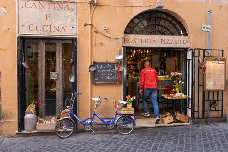 a man standing at the entrance to a shop on a city street