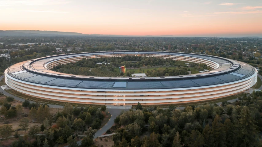 a large round building with a tree around it