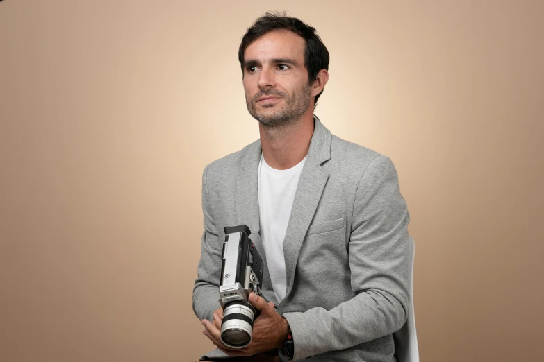 a man holding a camera in his right hand