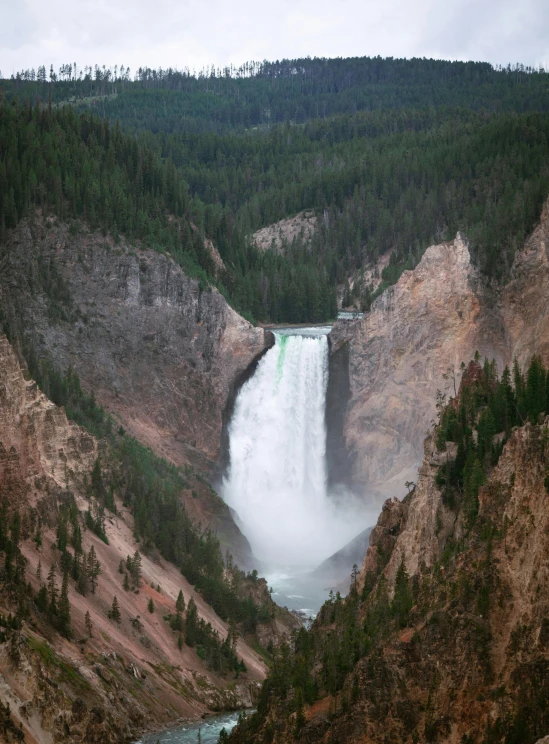 a tall waterfall with many falls at each side of it