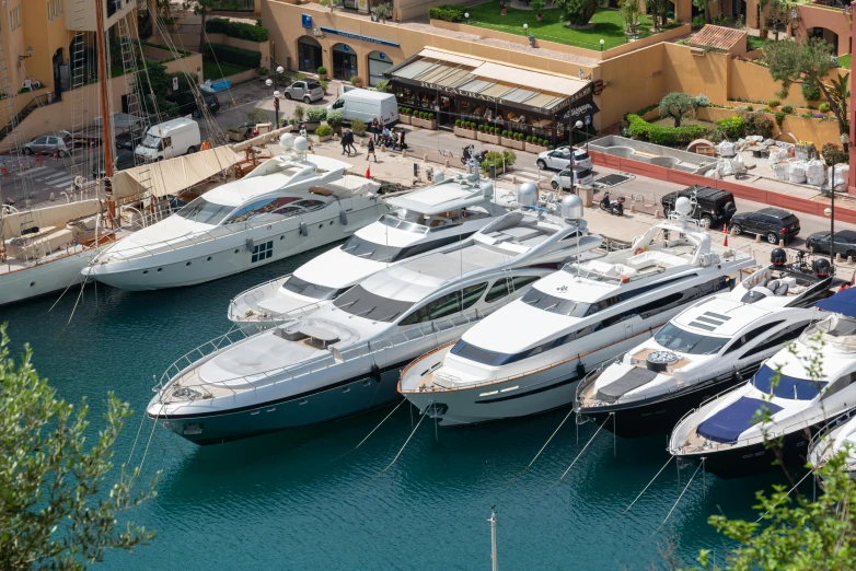 many small boats at a dock in front of an airport