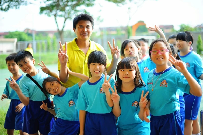 a girl and her soccer team are giving the peace sign