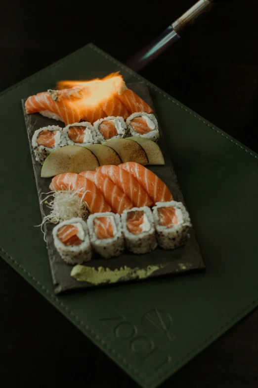 a sushi platter with fish, and fruit