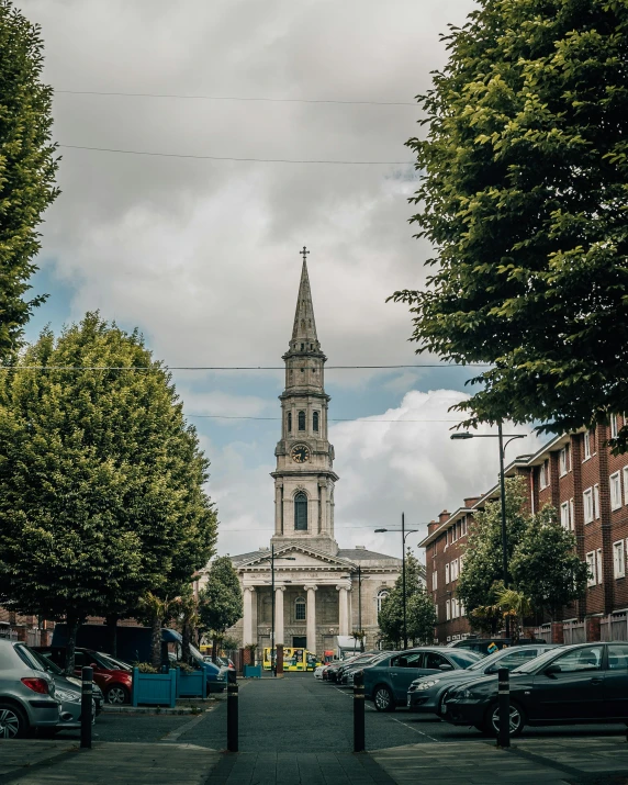 an old church has steeple in the middle of a street