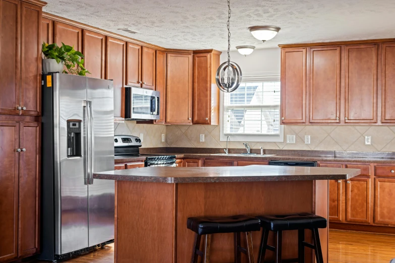 a kitchen with wooden cabinets and stainless steel appliances