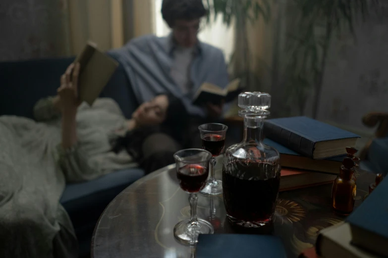 a man is reading a book and drinking