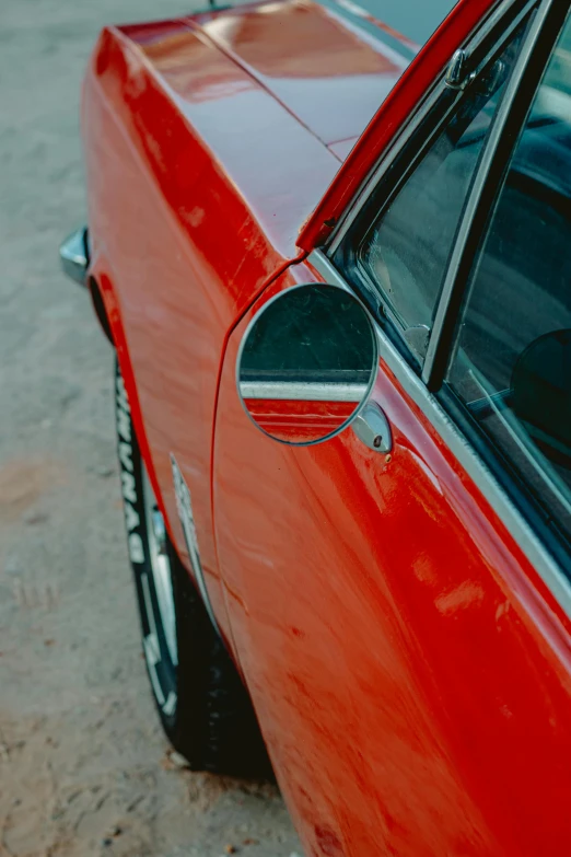 the rear end of an older model car with the door handle down