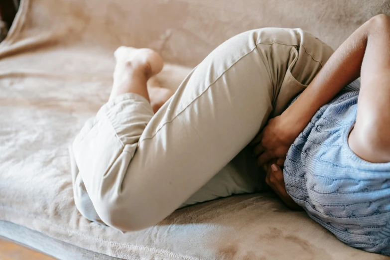 a man laying his head on the back of a couch