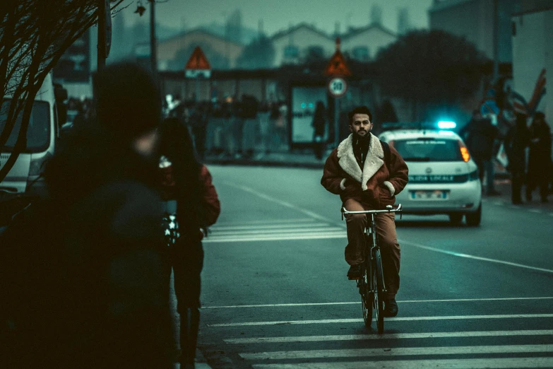 man riding a bicycle in the middle of the street