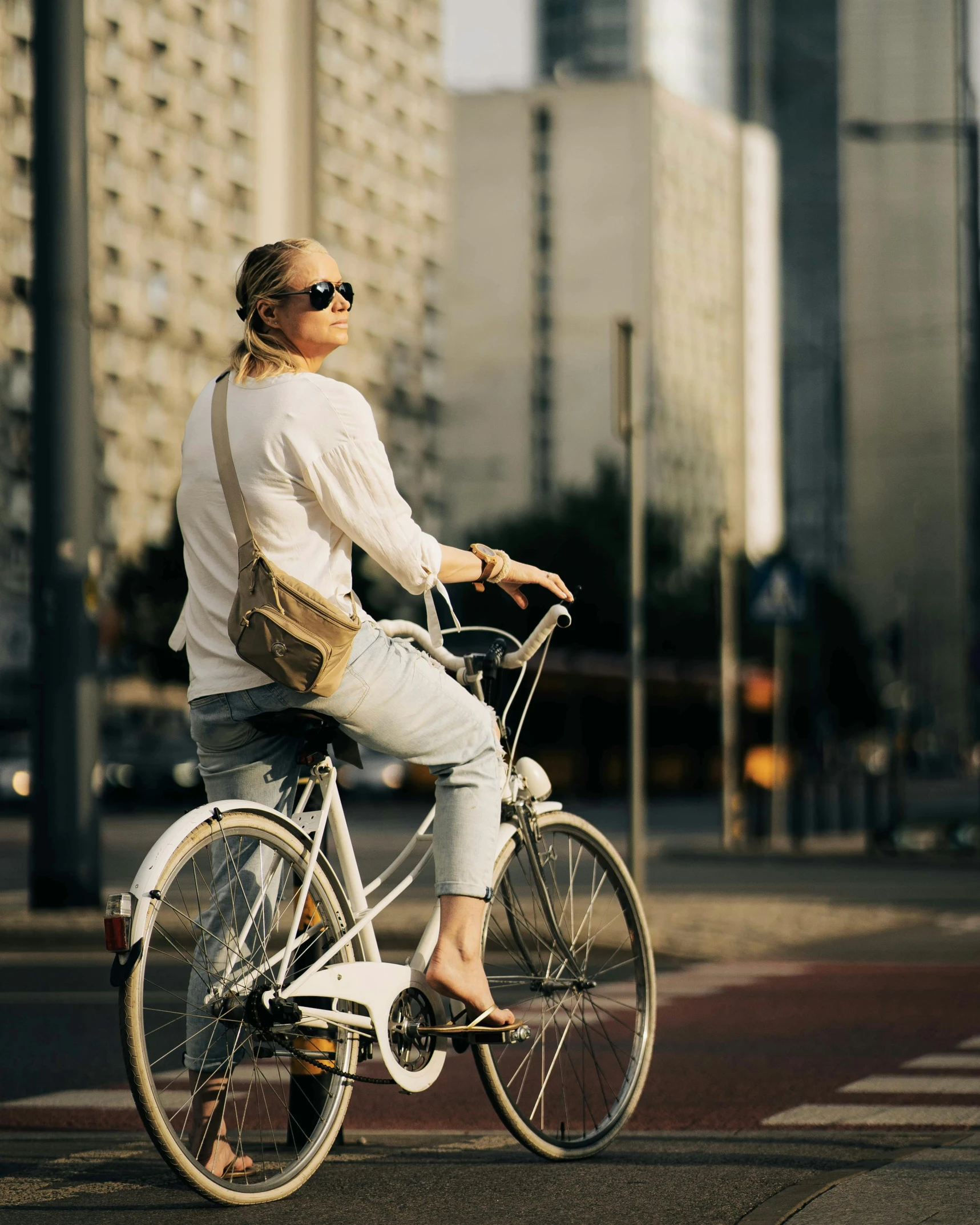 the woman is riding her bicycle down the road