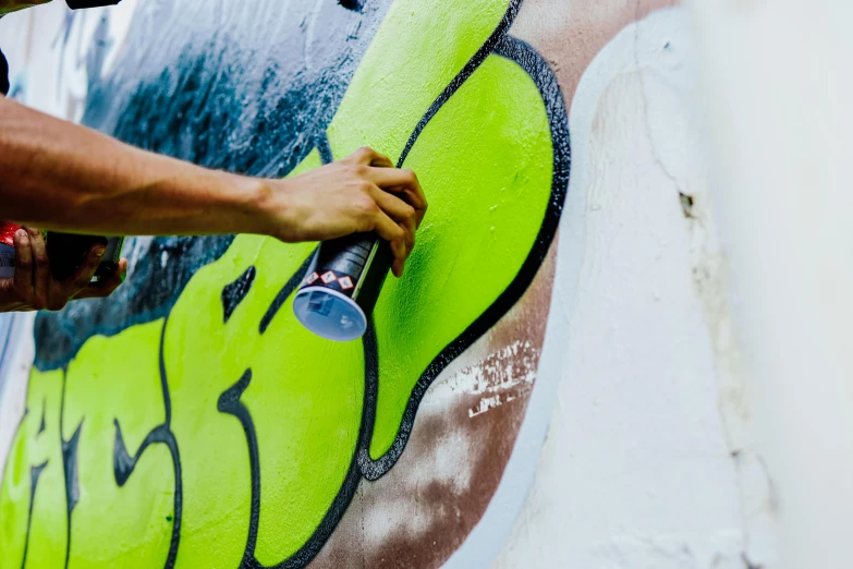 a person painting the side of a skateboard