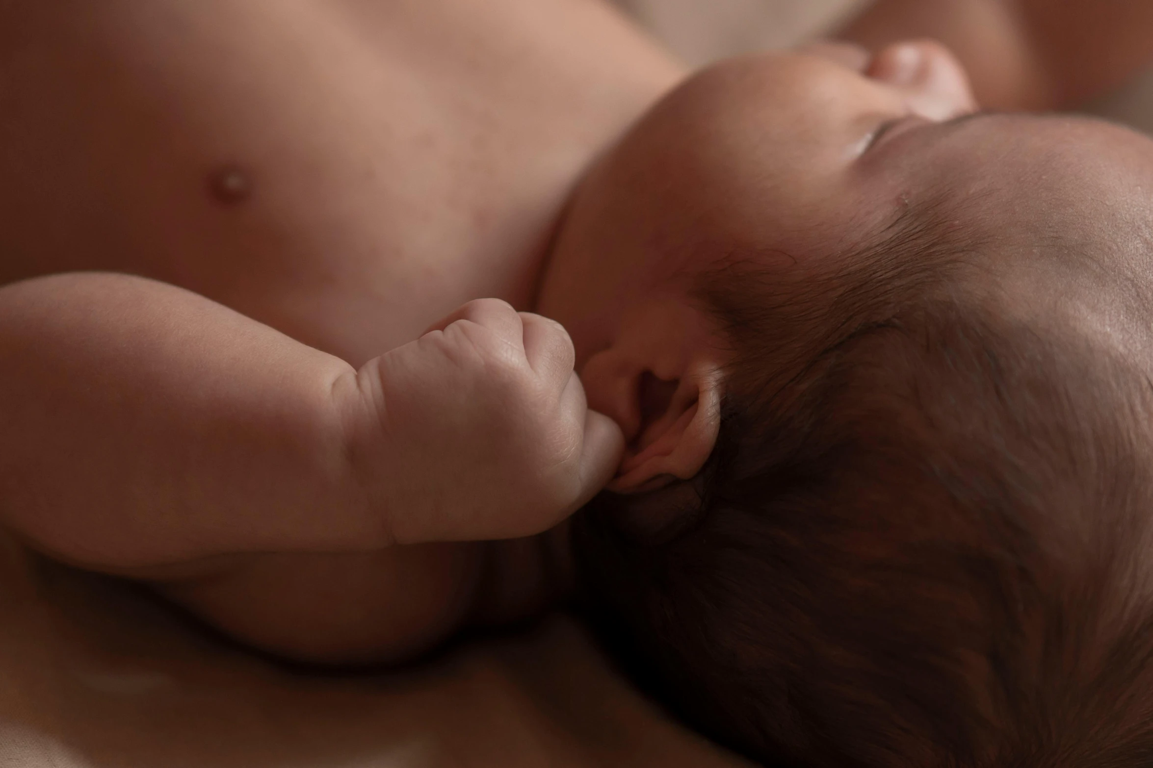 a baby is laying down asleep with his head on it