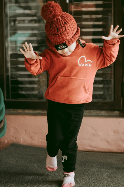 a small child dressed up and wearing a red hat