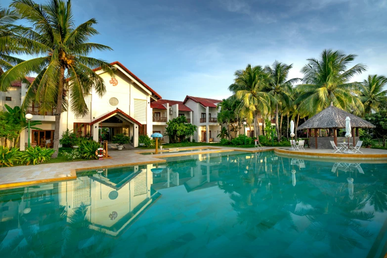 a pool with two chairs around it next to a building