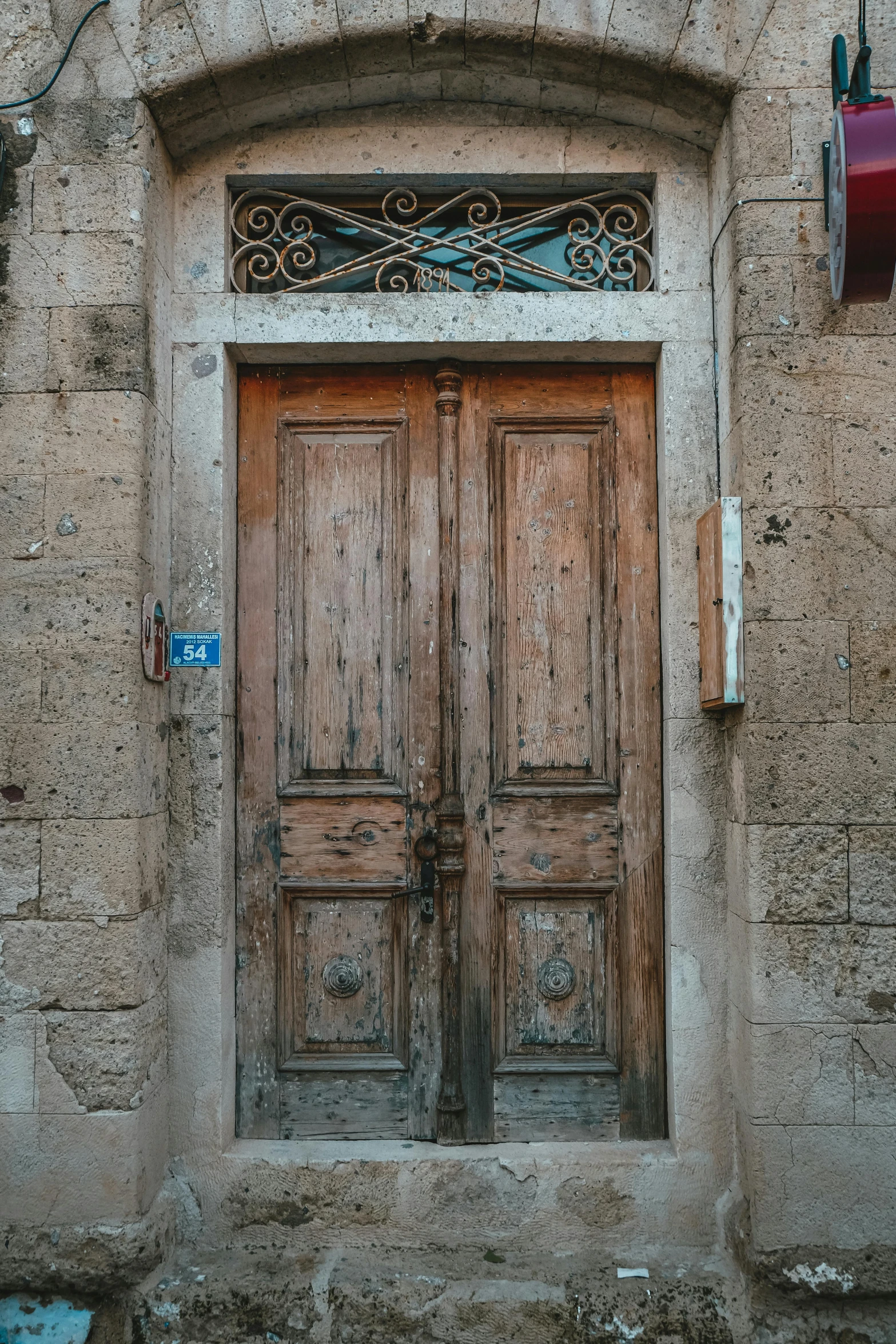 two wood doors next to each other on a building