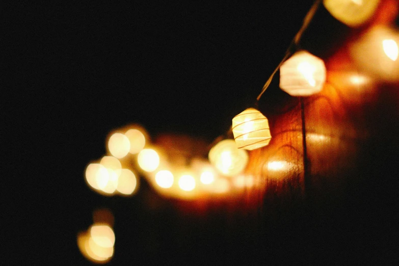 some paper lights that are glowing on a black background