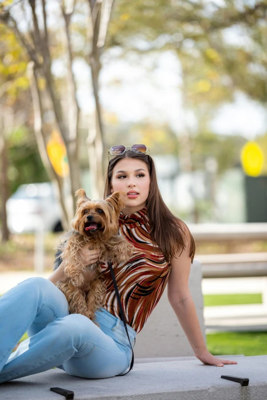 a woman holds her dog on her lap