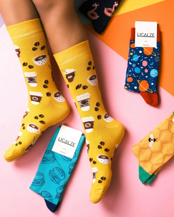 three pairs of socks with the word happy socks on them