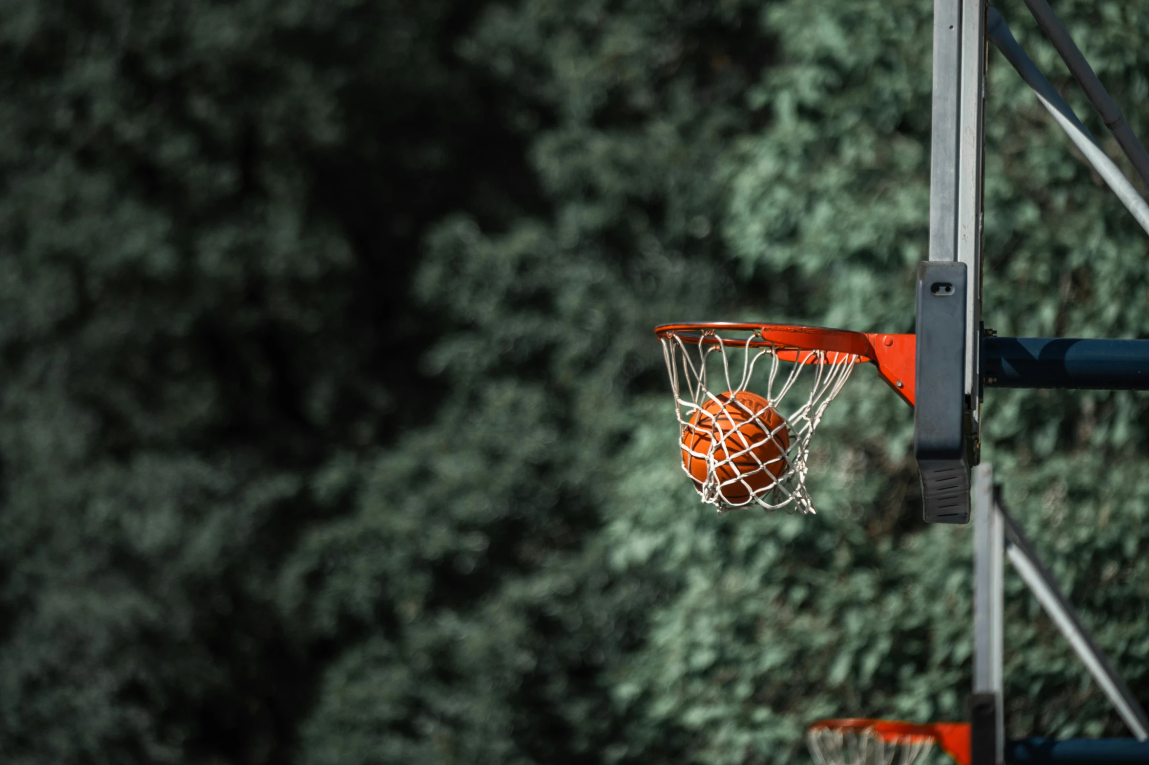 an orange basketball net with the net missing