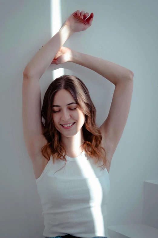 woman stretching with hands up on her head