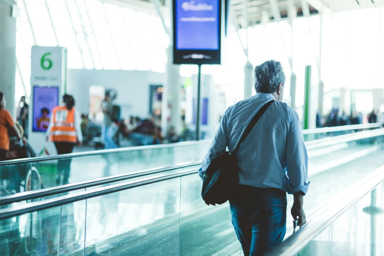 a person is pulling luggage on an escalator