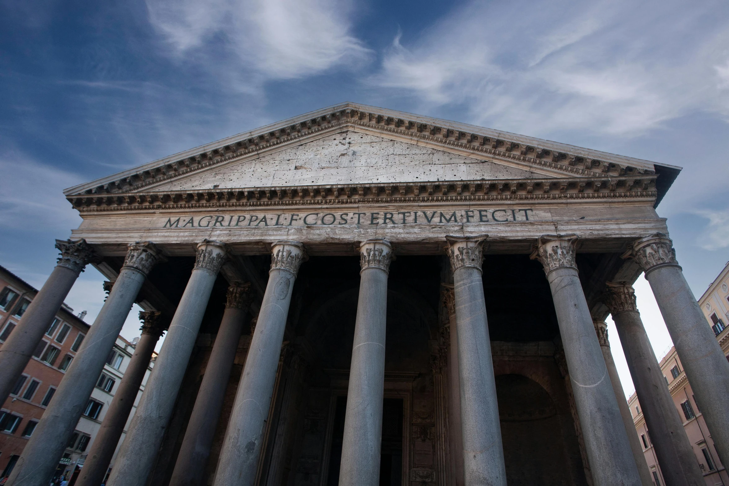 a large stone building has columns and a sign on it