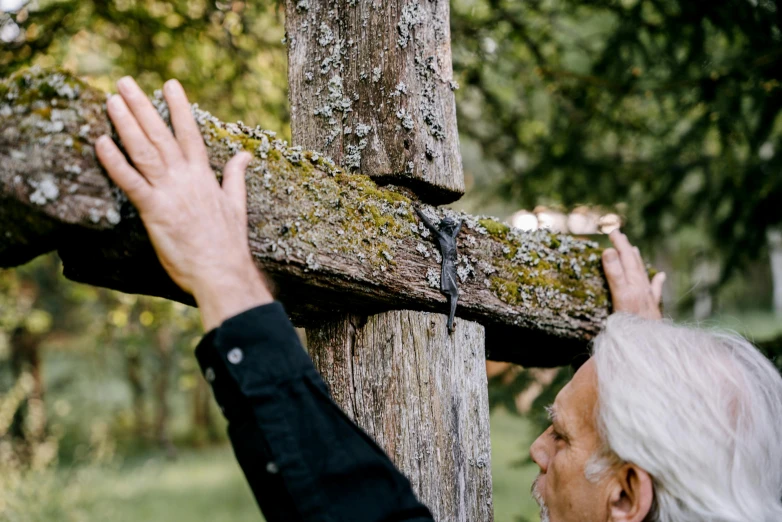 a person carrying a cross while standing on the ground