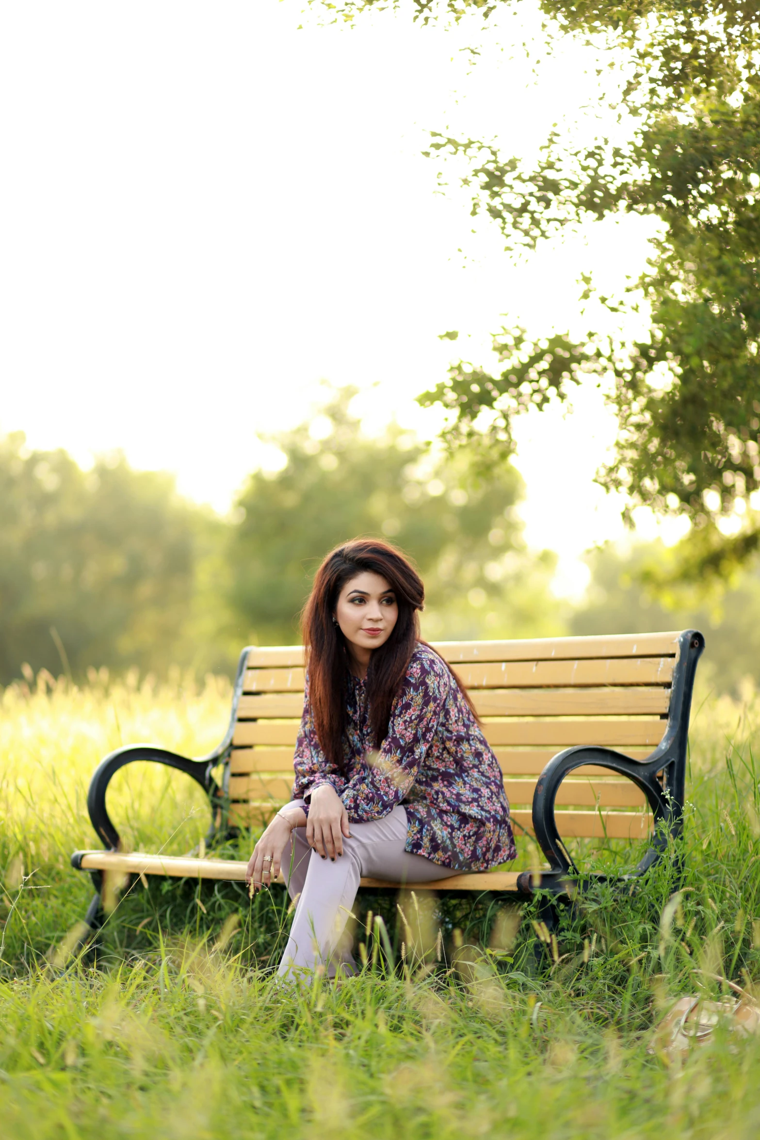 a young woman posing for a pograph on a bench