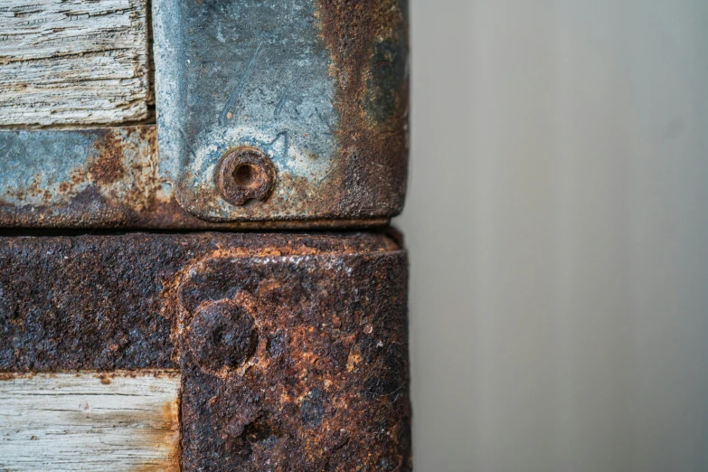 a rusted metal object sitting on top of a wood table