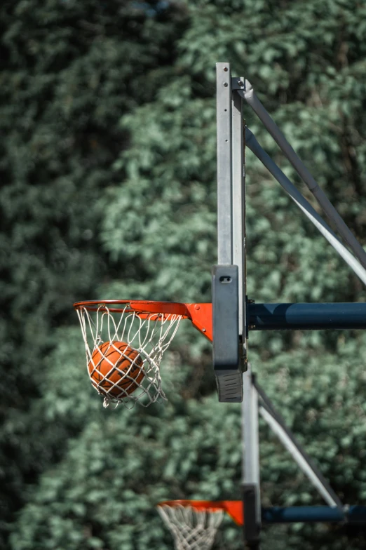basketball hoop being thrown to the side in an open field
