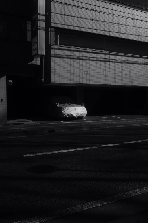 an empty parking lot sits near the large building