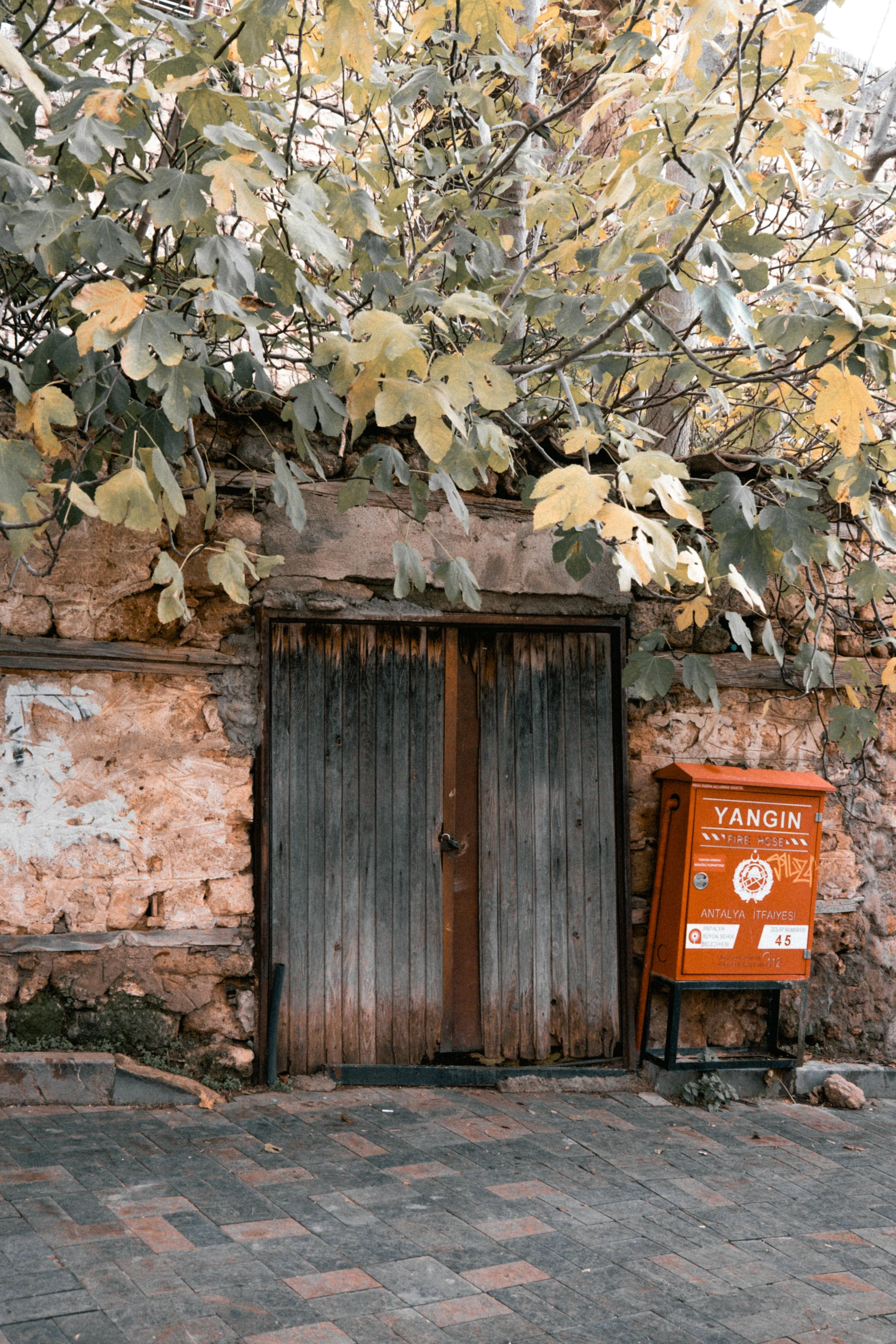 a red sign next to two wooden doors