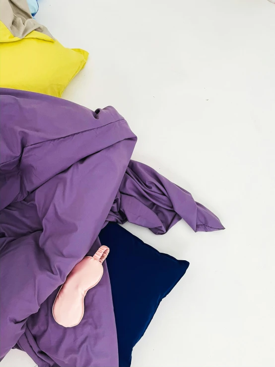 four different colors of comforter lying next to each other