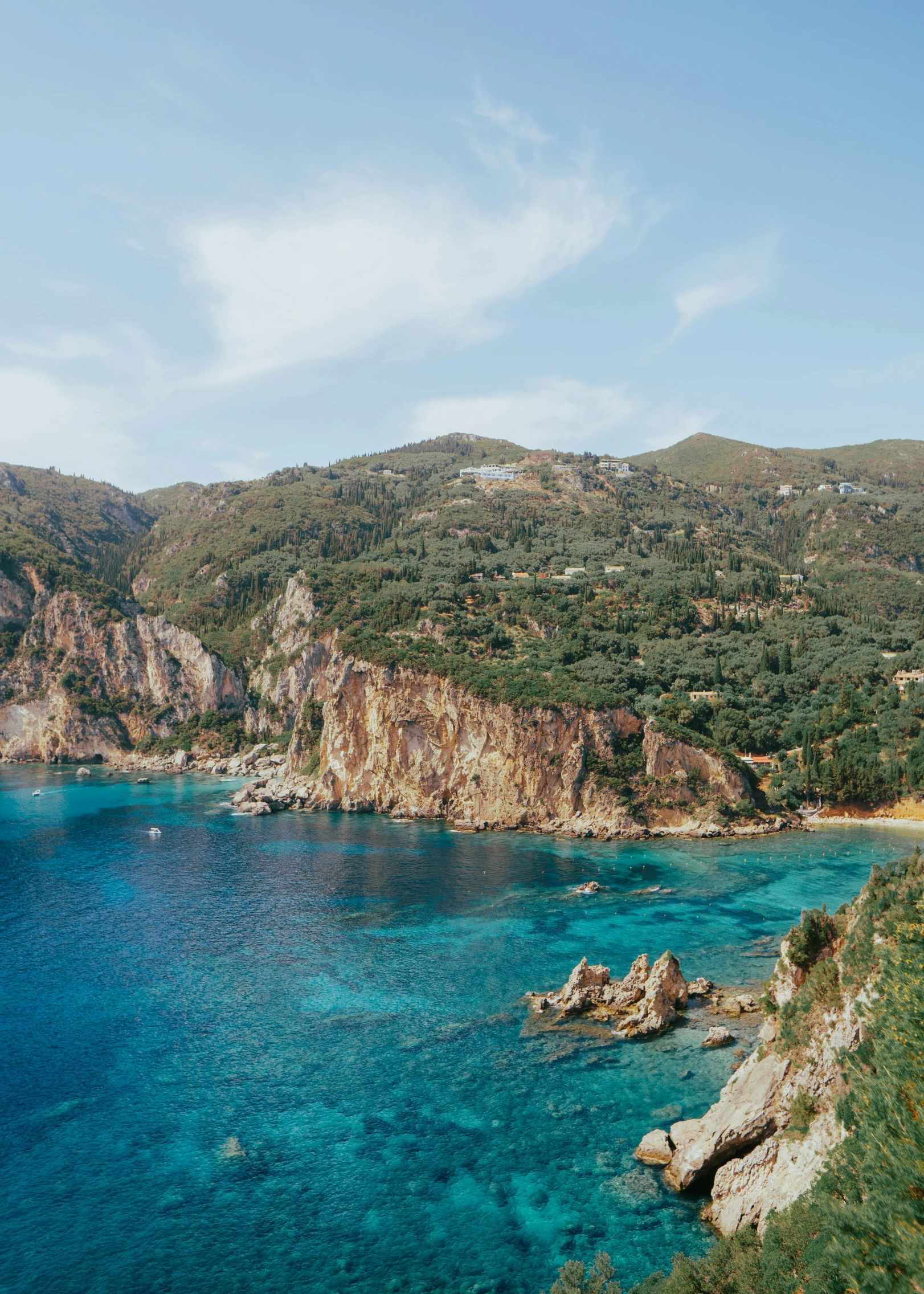 a blue body of water surrounded by rocky coastline