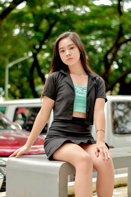 young asian woman sitting on a concrete bench