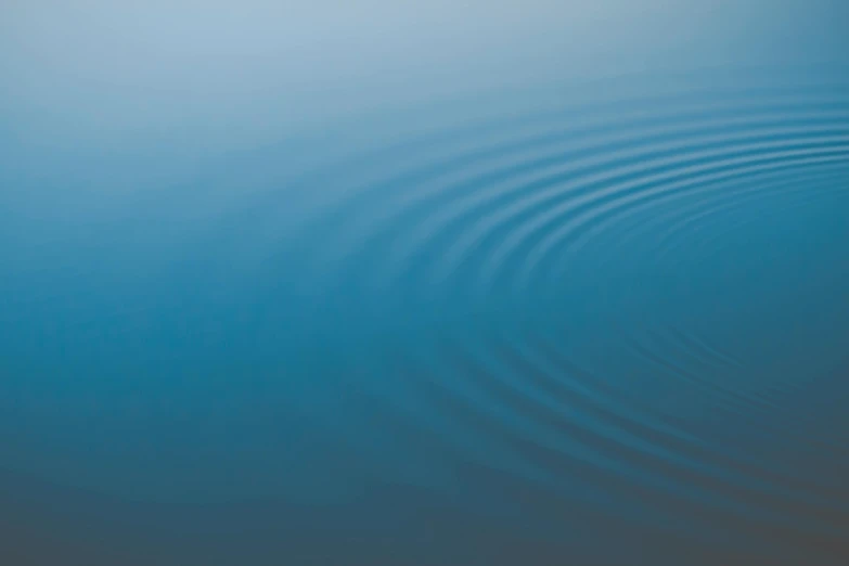 a blue water with a line of ripples