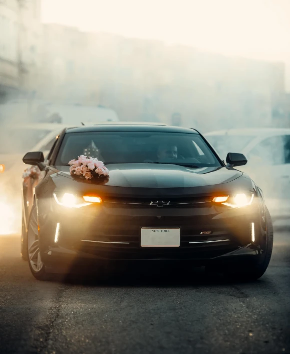 an automobile is shown with wedding decorations on the hood