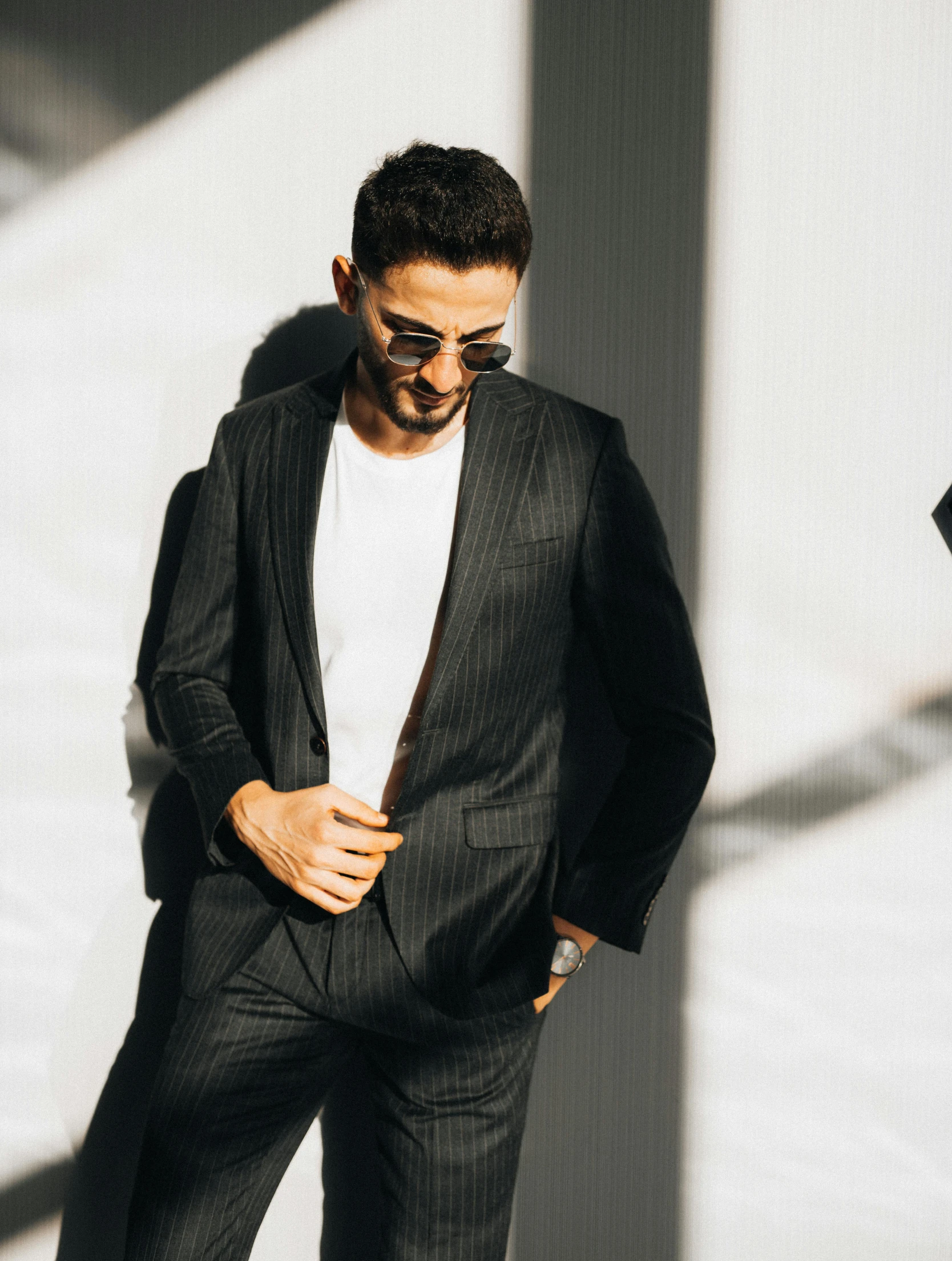 a man in sunglasses is wearing a suit