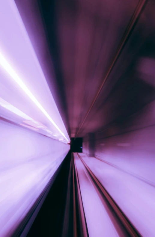 a blurry image of a train traveling down the tracks