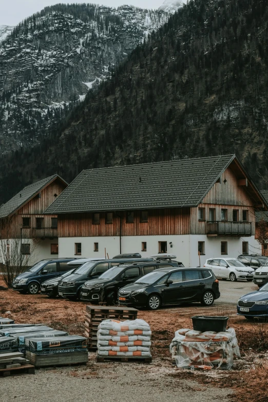 a mountain side with an old barn next to it