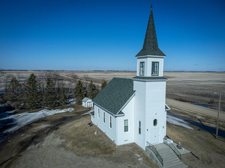 an aerial view of an old white church