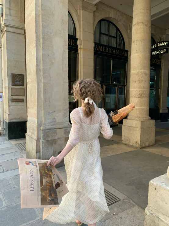 a woman with long hair walking down the street