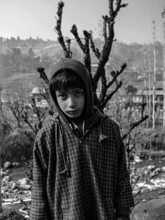 a black and white po of a young man wearing a hooded over shirt