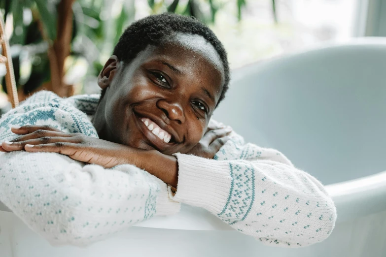 a woman is leaning her back on a chair