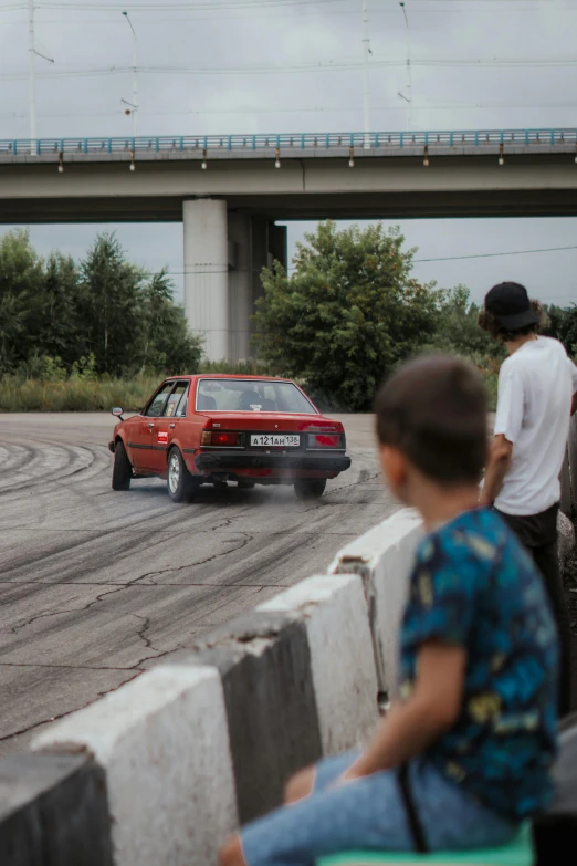 the red truck is driving by an overpass