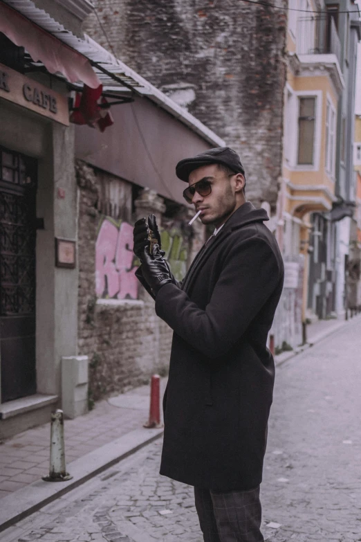 a man is standing on the street and smoking