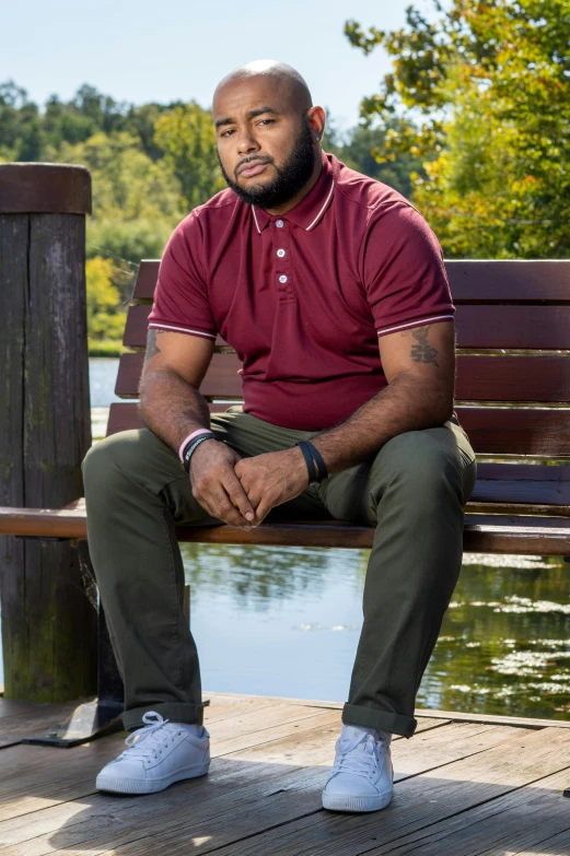 a bald man is sitting on a bench