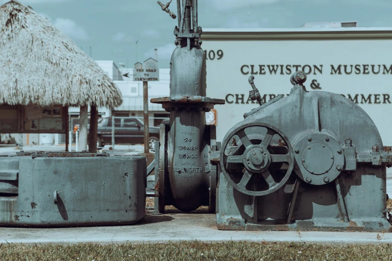 large old machinery sits outside of a museum