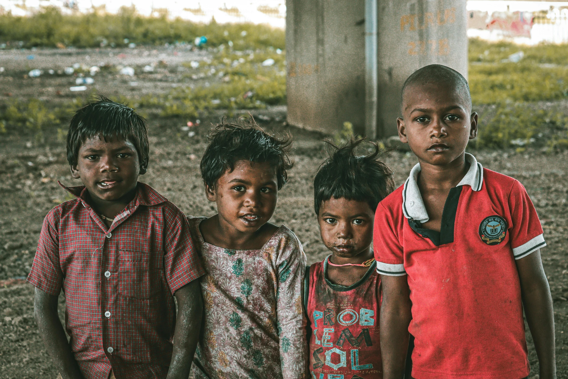 four young children stand next to each other